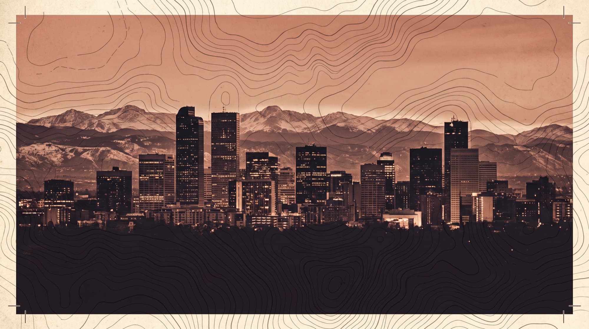 Downtown Denver skyline with the Front Range behind at dusk