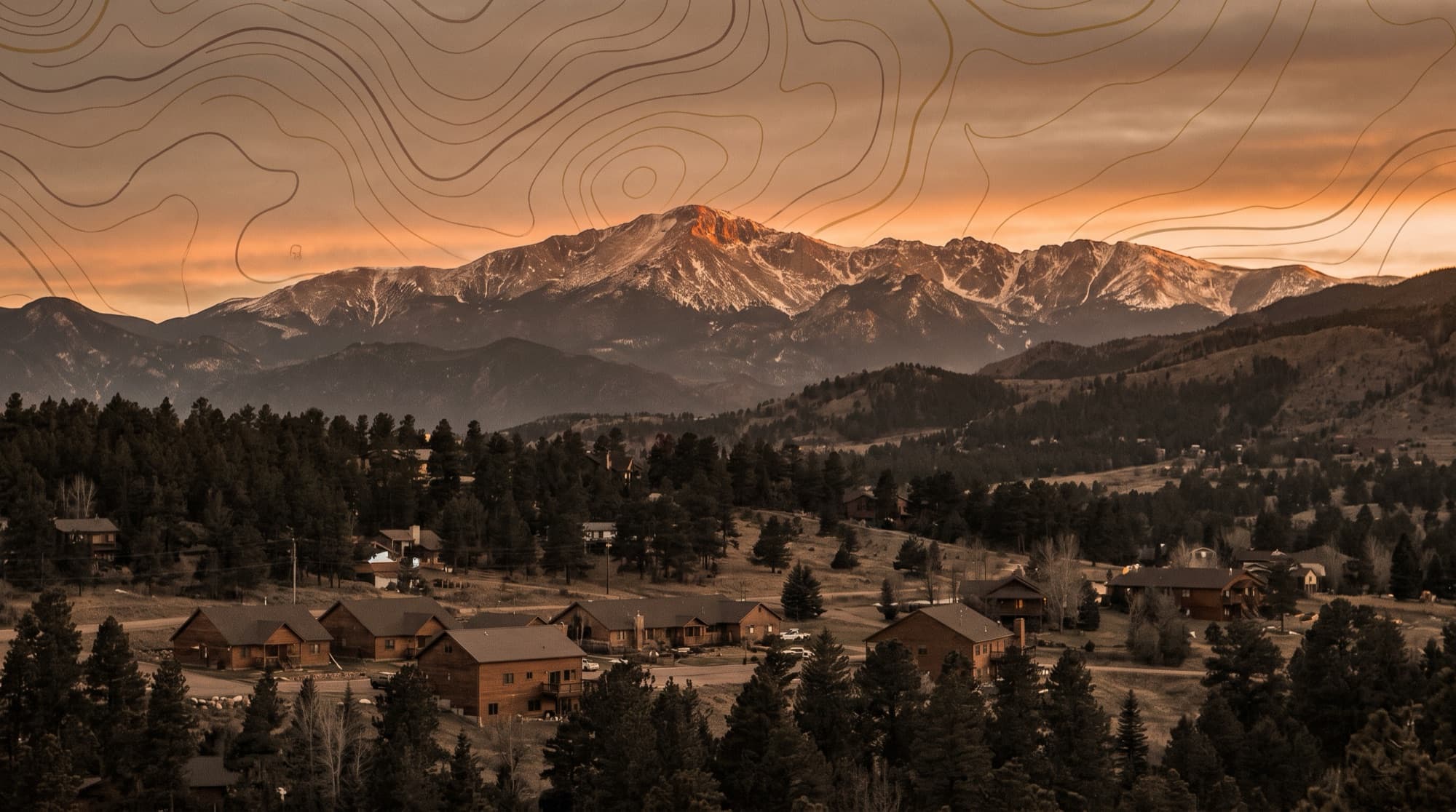 The mountain town of Woodland Park below the snow-dusted west face of Pikes Peak at sunset in Teller County, Colorado